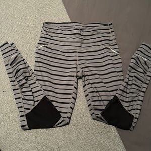 ATHLETA grey and black striped relay tight with reflective detail